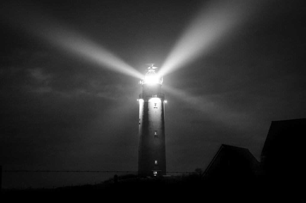 Light from a lighthouse shining in the dark
